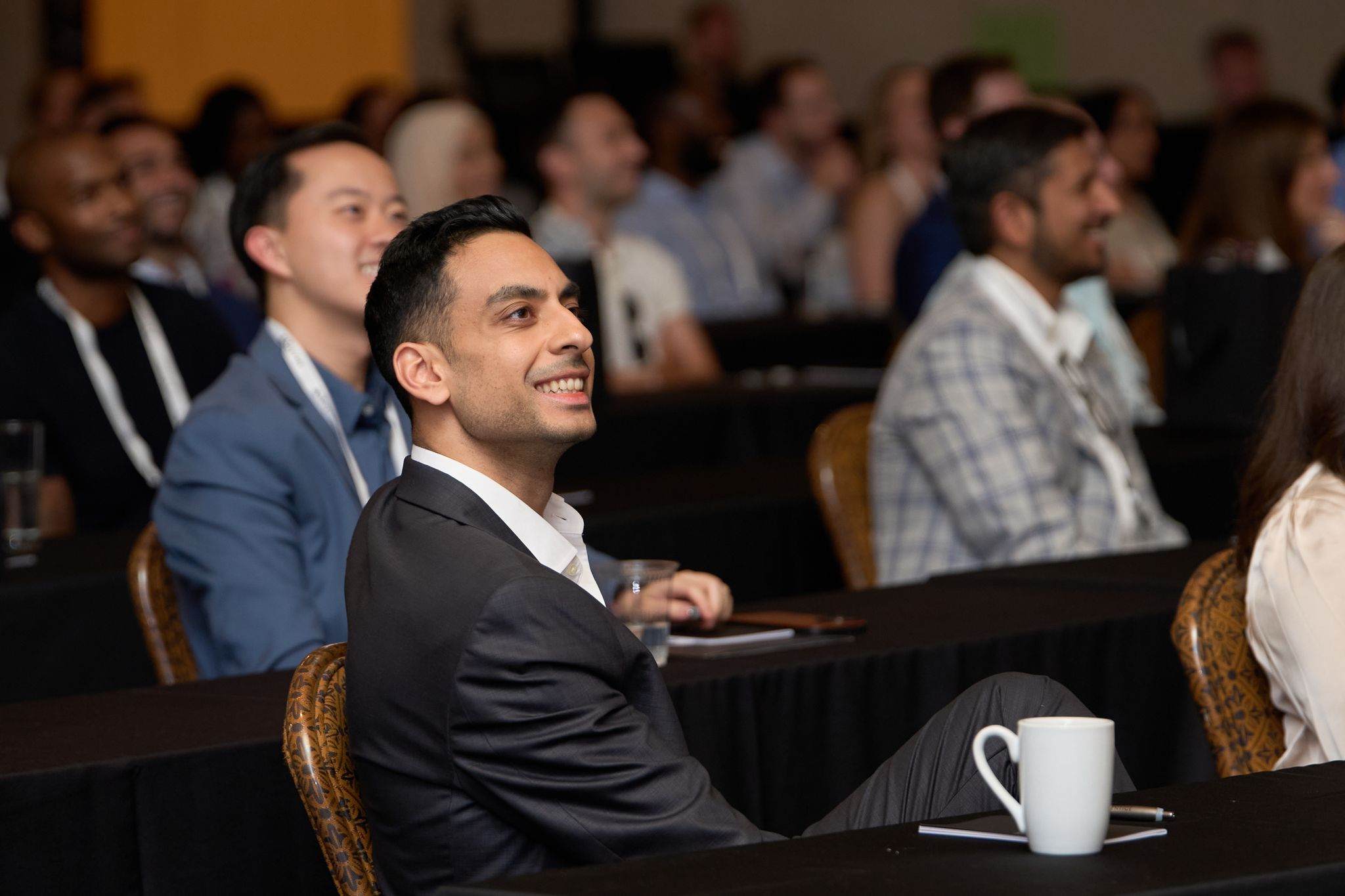 An engaged attendee smiling during a session