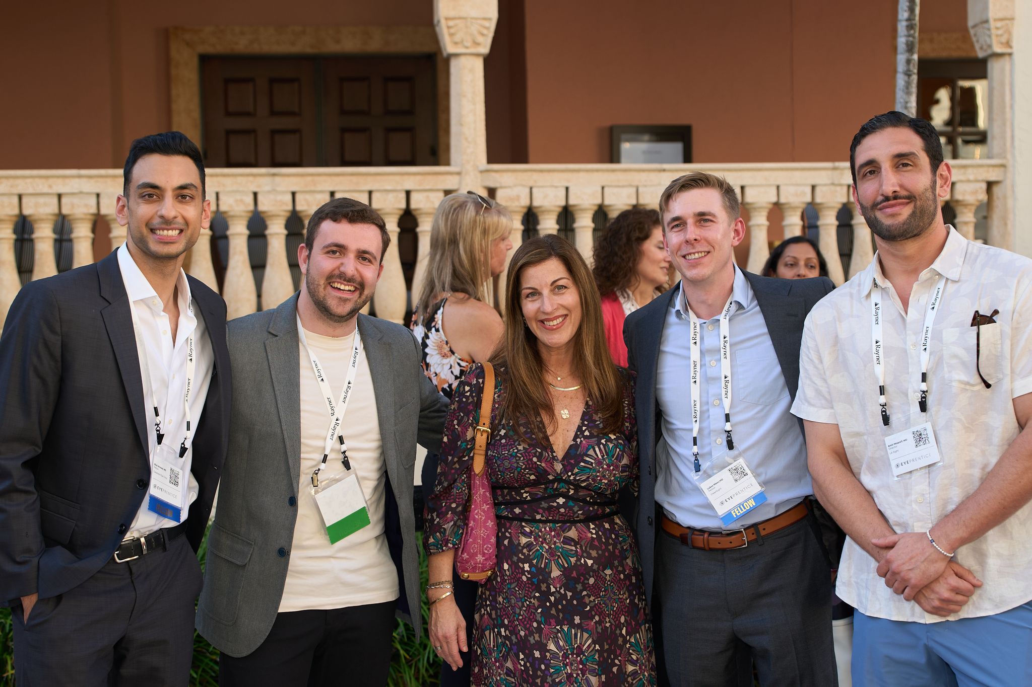 A group of attendees smiling together at the evening reception