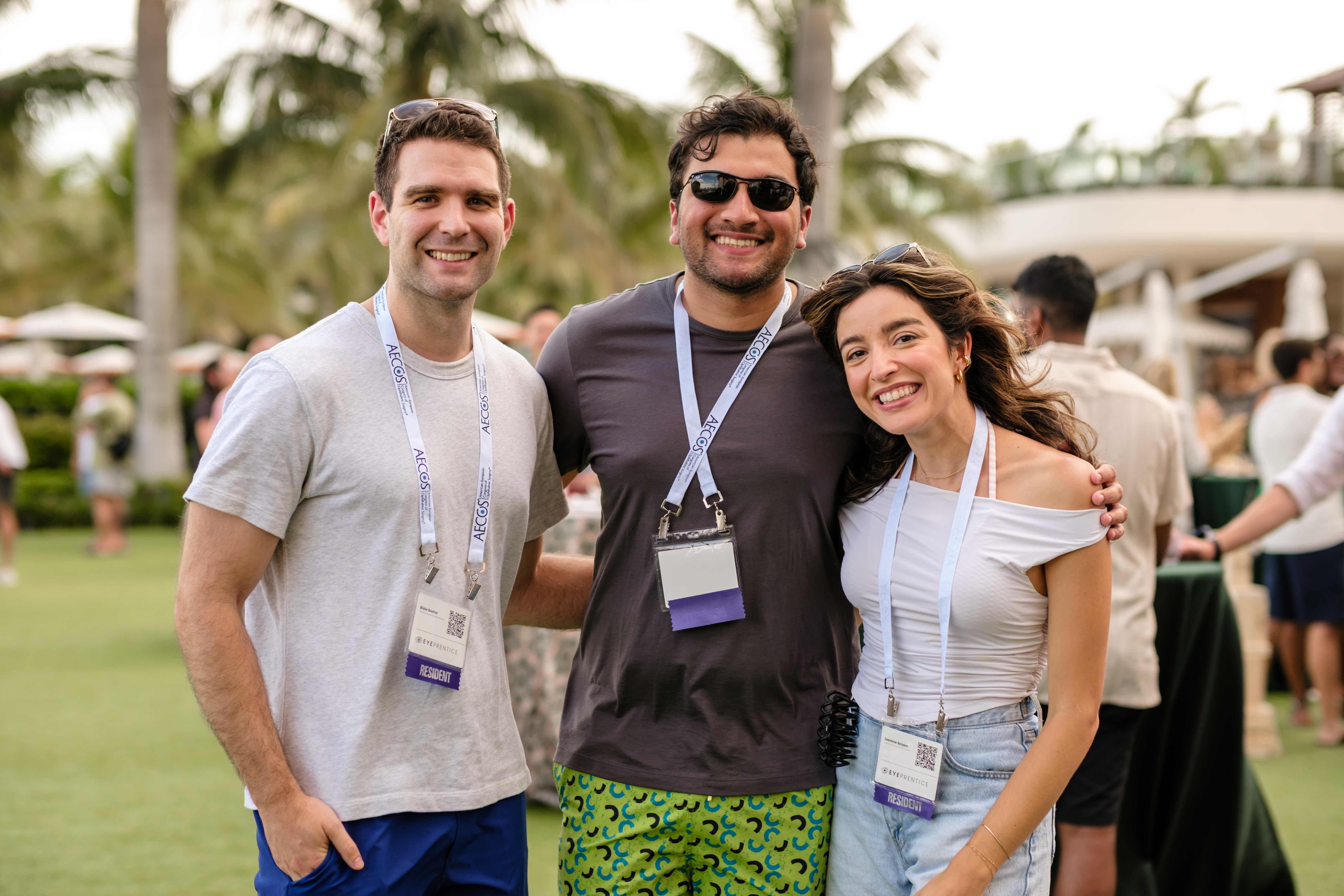 Three residents posing together outdoors during a Showcase reception